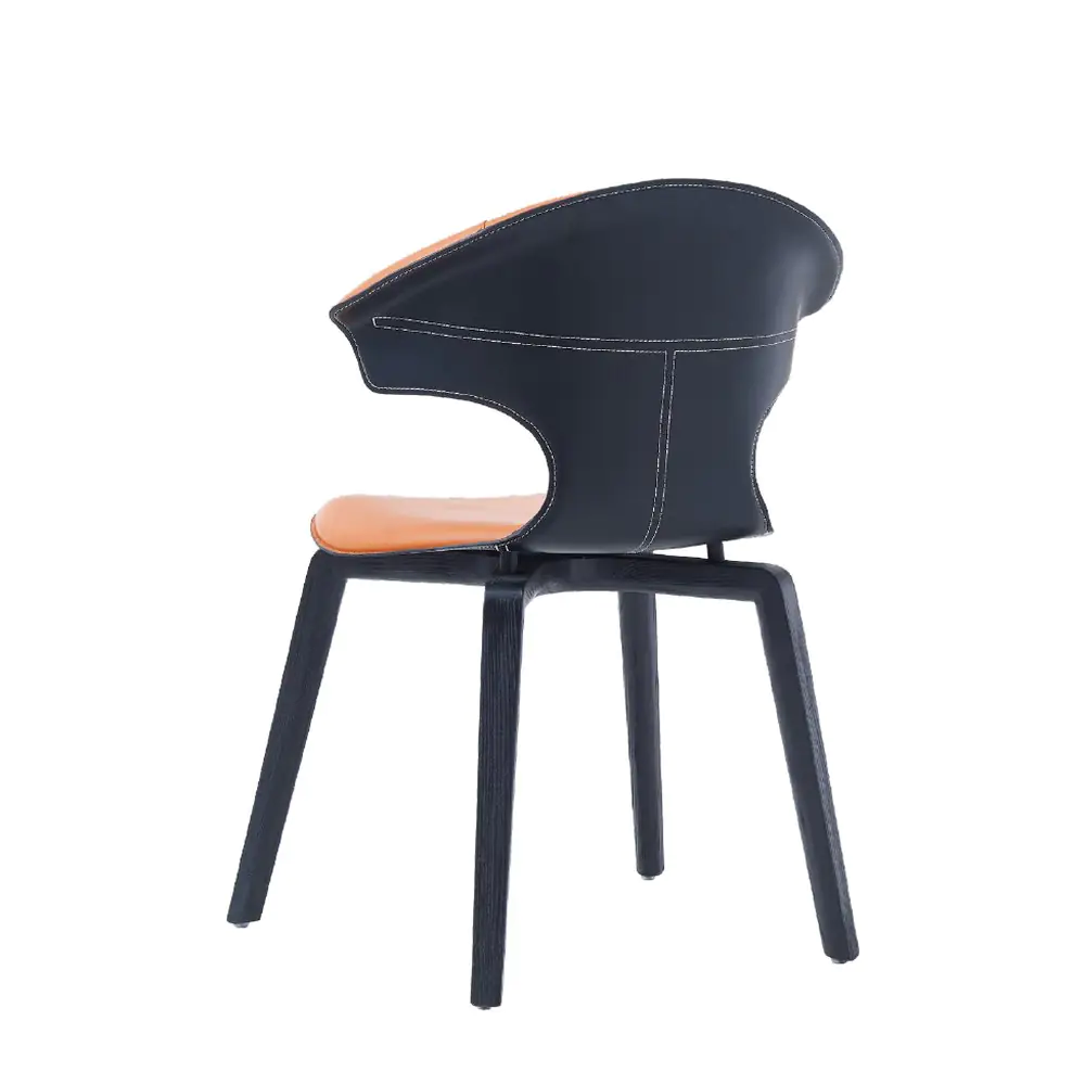 Taurus Winged Leather Chair - a flared orange leather back on dark curved legs (alternate view)